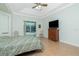 Bedroom features tray ceiling, ceiling fan, dresser, and sliding glass door to the pool at 2629 Rolling Rd, North Port, FL 34288