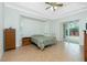 Spacious bedroom with tile flooring, a ceiling fan, and a sliding glass door at 2629 Rolling Rd, North Port, FL 34288