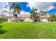 Well-manicured lawn and view of the home's exterior with attached garage at 2629 Rolling Rd, North Port, FL 34288