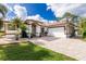 Charming home with a paver driveway, well-maintained landscaping, and an attached two-car garage at 2629 Rolling Rd, North Port, FL 34288