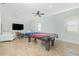 Spacious game room with a large pool table, tile flooring, and comfortable seating at 2629 Rolling Rd, North Port, FL 34288