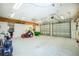 Spacious three-car garage with epoxy floor and storage racks at 2629 Rolling Rd, North Port, FL 34288