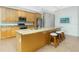 Bright eat-in kitchen with stainless steel appliances, breakfast bar, and granite countertops at 2629 Rolling Rd, North Port, FL 34288