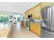 Spacious eat-in kitchen with tile floors, light wood cabinets, stainless appliances, and granite countertops at 2629 Rolling Rd, North Port, FL 34288