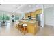 Bright eat-in kitchen with stainless steel appliances, breakfast bar, and granite countertops at 2629 Rolling Rd, North Port, FL 34288