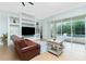 Living room with tile floors, built-in shelving, and sliding glass doors to the pool at 2629 Rolling Rd, North Port, FL 34288
