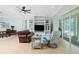 Living room with tile floors, built-in shelving, and access to screened-in patio at 2629 Rolling Rd, North Port, FL 34288