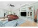 Comfortable living room featuring built-in shelving, ceiling fan, tile floors, and modern furniture at 2629 Rolling Rd, North Port, FL 34288