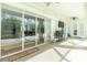 The screened patio features a ceiling fan, grill, and multiple seating areas at 2629 Rolling Rd, North Port, FL 34288