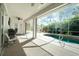 Covered patio featuring ceiling fan, grill, seating, and screen enclosed pool at 2629 Rolling Rd, North Port, FL 34288