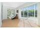 Screened-in patio with tile floors, lounge chair, and view of the pool area at 2629 Rolling Rd, North Port, FL 34288