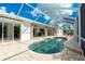 Screened-in pool with an expansive deck and a view of the home's patio at 2629 Rolling Rd, North Port, FL 34288
