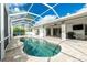 Screened-in pool with clear blue skies overhead and access to lanai at 2629 Rolling Rd, North Port, FL 34288