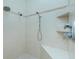 Shower with dual shower heads, built-in shelves, and a corner seat at 2629 Rolling Rd, North Port, FL 34288