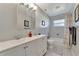 Bright bathroom featuring a double sink, a bathtub with a shower, and neutral decor, offering a clean and functional design at 2916 Woodcrest Dr, Sarasota, FL 34239