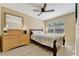 Serene bedroom with a comfortable bed, a dresser, and a mirror, enhanced by natural light and neutral tones at 2916 Woodcrest Dr, Sarasota, FL 34239