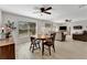 Inviting dining area featuring wood floors, a ceiling fan and views into the living room at 2916 Woodcrest Dr, Sarasota, FL 34239