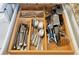 Organized kitchen drawer with silverware and utensils neatly arranged, showcasing efficient storage solutions for cooking essentials at 2916 Woodcrest Dr, Sarasota, FL 34239