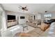 Bright living room featuring a comfortable sofa, modern furnishings and a wall-mounted fireplace at 2916 Woodcrest Dr, Sarasota, FL 34239