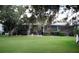 View of backyard with screen enclosed patios and large grassy area at 323 Bobby Jones Rd # 323, Sarasota, FL 34232