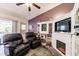 Cozy living room featuring a fireplace and two plush leather recliners at 323 Bobby Jones Rd # 323, Sarasota, FL 34232