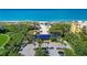 Aerial view of the private Bay Isles Beach Club on a pristine sandy beach with turquoise water at 3303 Sabal Cove Cir, Longboat Key, FL 34228
