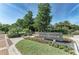 Bay Isles Beach Club entrance with lush landscaping, colorful flowers, and decorative signage at 3303 Sabal Cove Cir, Longboat Key, FL 34228
