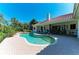 Stunning pool area with lush landscaping, comfortable lounge chairs, and a view of the beautiful home at 3303 Sabal Cove Cir, Longboat Key, FL 34228