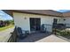 Exterior balcony with chairs, with exterior view and sliding glass door to bedroom at 3390 Ramblewood Ct, Sarasota, FL 34237