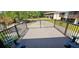 Exterior balcony with black metal railing, view of the parking area and neighboring building at 3390 Ramblewood Ct, Sarasota, FL 34237