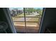 View from the balcony shows a fenced-in wooden deck overlooking a street and green space at 3390 Ramblewood Ct, Sarasota, FL 34237