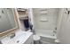 Clean, bright bathroom featuring a vanity with storage, toilet, and tub at 3390 Ramblewood Ct, Sarasota, FL 34237