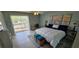 Bright bedroom with ceiling fan, sliding glass doors and a private balcony with view at 3390 Ramblewood Ct, Sarasota, FL 34237