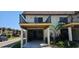 Inviting two-story condo features a covered parking area and quaint landscaping at 3390 Ramblewood Ct, Sarasota, FL 34237