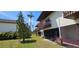 Exterior lawn view of a two-story building with brown balconies, lush green grass and landscaping at 3390 Ramblewood Ct, Sarasota, FL 34237