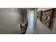 Hallway with wood-look floors and modern decor and railing at 3390 Ramblewood Ct, Sarasota, FL 34237