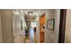 Inviting hallway leading to a bright living space, featuring tiled floors and beach themed decor at 3390 Ramblewood Ct, Sarasota, FL 34237