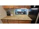 Kitchen granite countertops and a view of the living/dining area create an open and connected living space at 3390 Ramblewood Ct, Sarasota, FL 34237