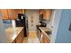 Compact kitchen with granite countertops, stainless steel appliances, and stylish decor at 3390 Ramblewood Ct, Sarasota, FL 34237