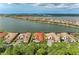 Gorgeous aerial view of lakeside homes, highlighting tile roofs, landscaping, and tranquil water views at 344 Maraviya Blvd, Nokomis, FL 34275