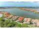 Stunning aerial view of lakeside homes, featuring tile roofs, lush landscaping, and tranquil water views at 344 Maraviya Blvd, Nokomis, FL 34275