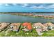 Spectacular aerial view of lakeside homes, boasting tile roofs, lush landscaping, and serene water views at 344 Maraviya Blvd, Nokomis, FL 34275