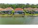 Tranquil backyard view with pool and screened-in lanai overlooking a peaceful lake, perfect for relaxing and entertaining at 344 Maraviya Blvd, Nokomis, FL 34275