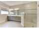 Bathroom featuring double sinks, modern fixtures, and a frameless glass walk-in shower at 344 Maraviya Blvd, Nokomis, FL 34275