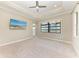 Spacious bedroom featuring a ceiling fan, large window overlooking the water, and neutral carpeting at 344 Maraviya Blvd, Nokomis, FL 34275