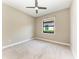 Comfortable bedroom with carpet, a ceiling fan, and a view of the outdoor scenery at 344 Maraviya Blvd, Nokomis, FL 34275