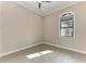 Bright bedroom with wood-look tile flooring, crown molding, and ample natural light from the window at 344 Maraviya Blvd, Nokomis, FL 34275