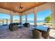 Covered patio with elegant seating, offering scenic views of the lake and providing a perfect space for relaxation at 344 Maraviya Blvd, Nokomis, FL 34275