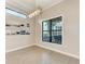 Dining room featuring a modern chandelier, neutral walls, and a large window overlooking the outdoor space at 344 Maraviya Blvd, Nokomis, FL 34275