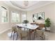 Formal dining room with plantation shutters, a modern marble table, comfortable seating, and stylish décor at 344 Maraviya Blvd, Nokomis, FL 34275